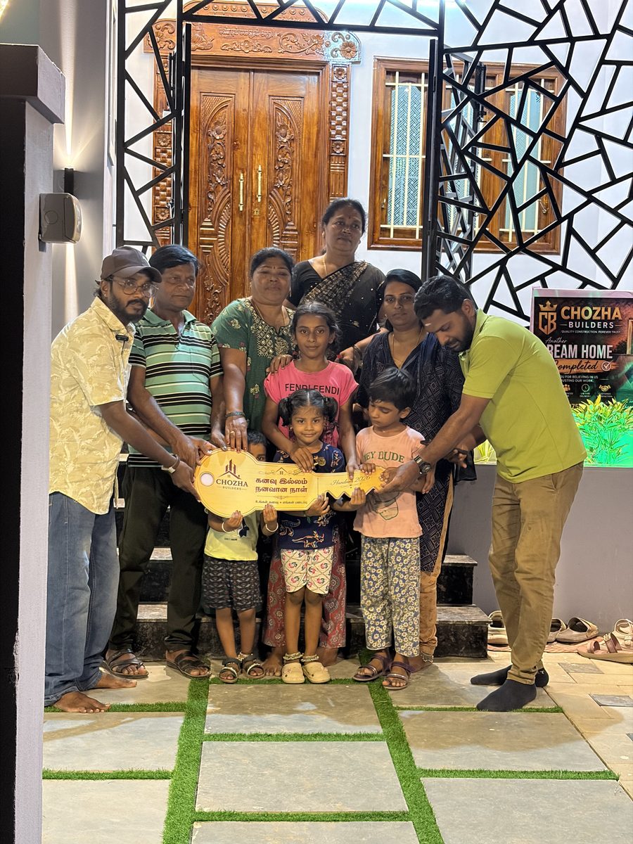 Happy family receiving keys to their dream home from Chozha Builders